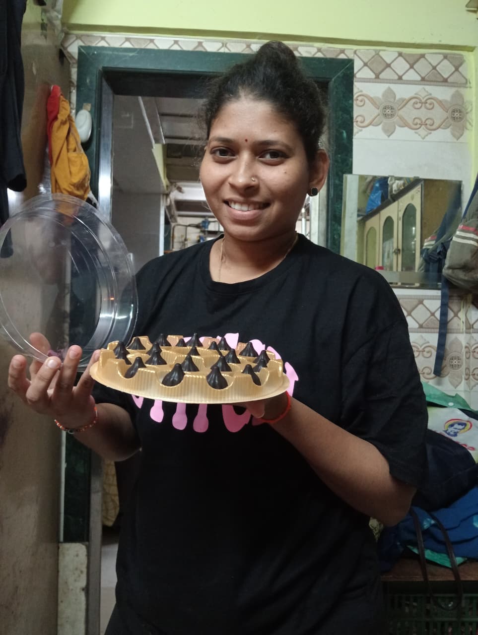 Rasika Patil holding a tray of chocolate modaks